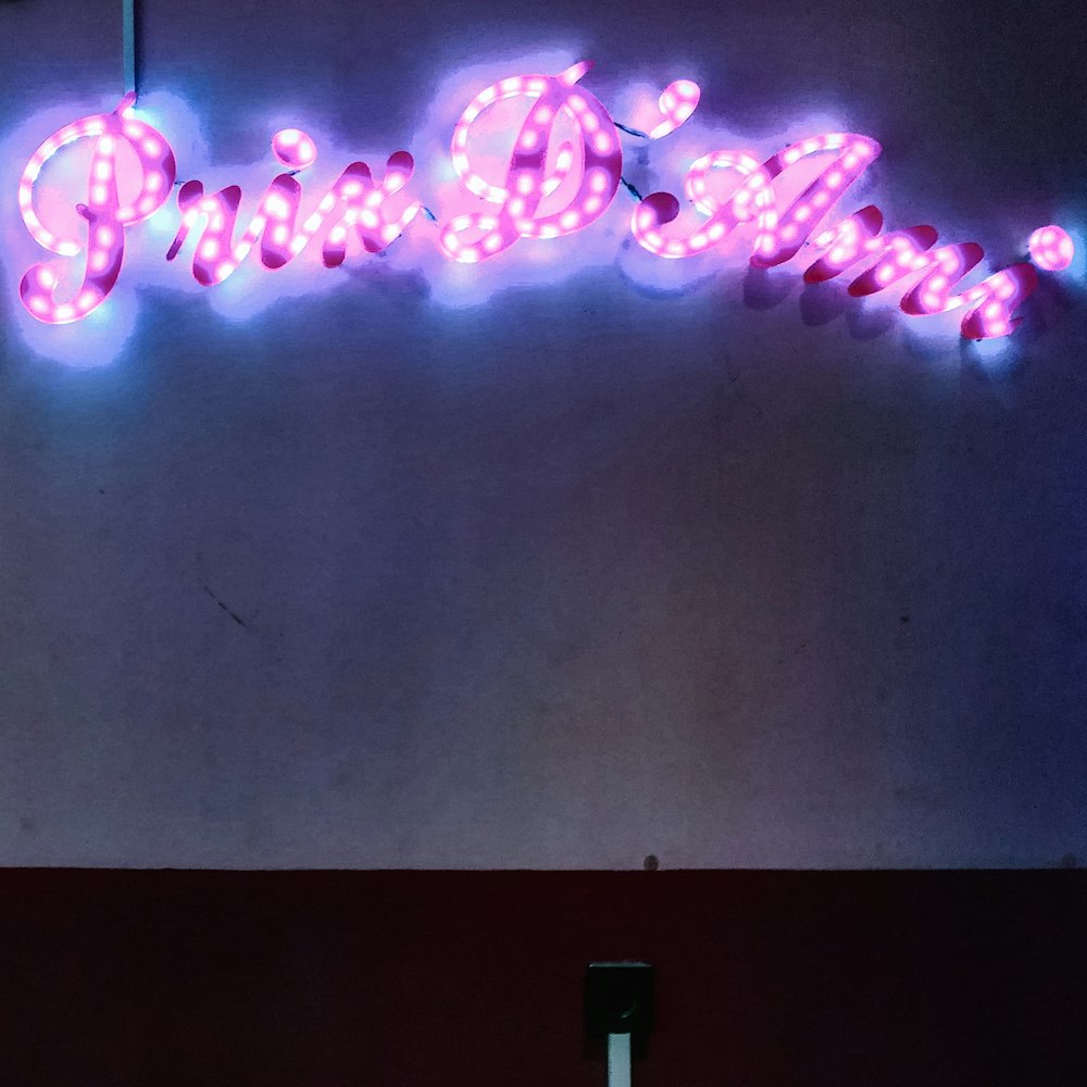 a neon sign with the word pink on it