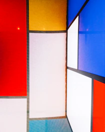 a multicolored room with a red, yellow, blue, and white wall