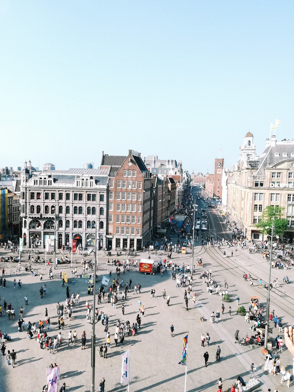 a large group of people walking around a city