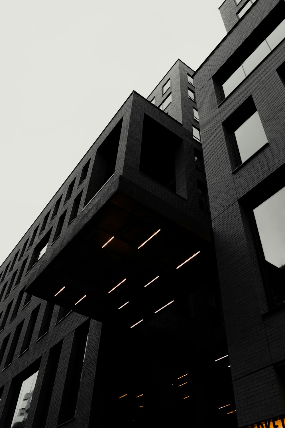 a tall black building with lots of windows