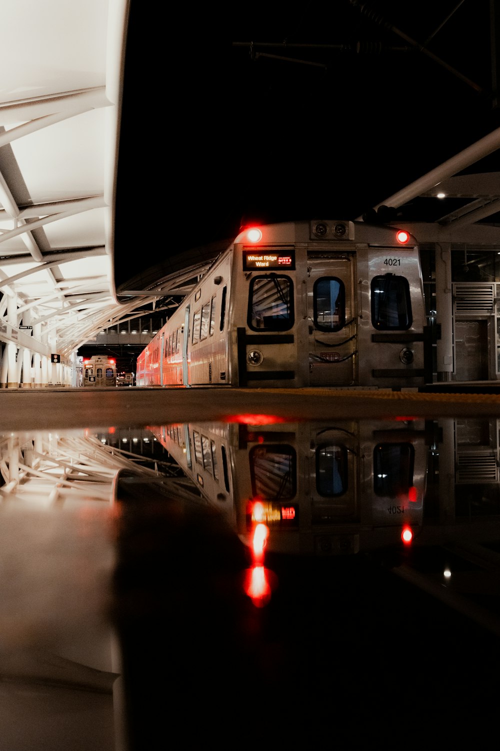 a train parked in a train station next to another train