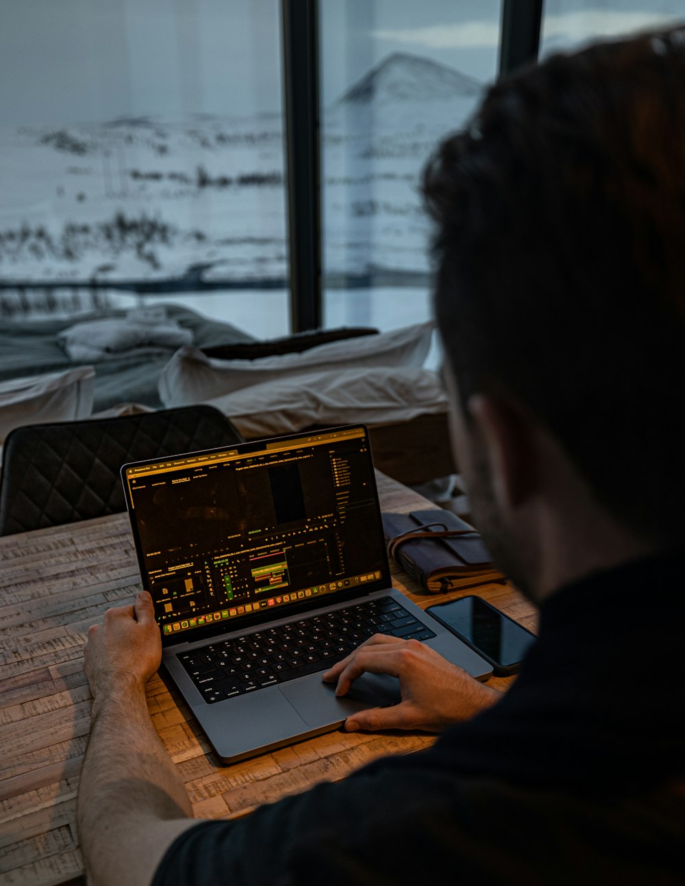 a man sitting in front of a laptop computer