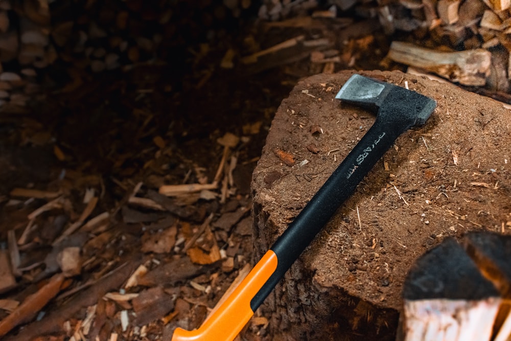 a hammer is laying on top of a pile of wood