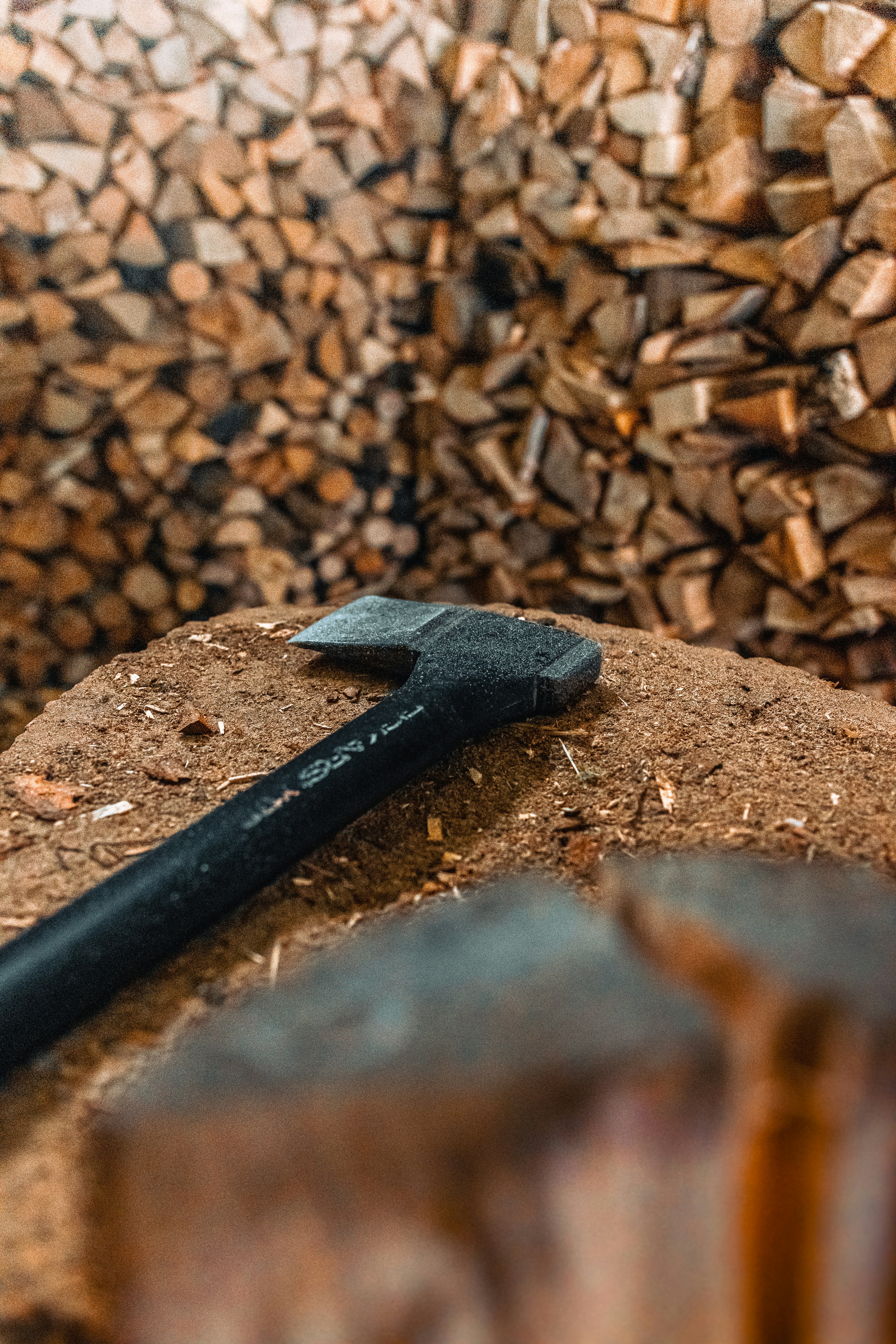 a hammer and a piece of wood sitting on top of a pile of wood
