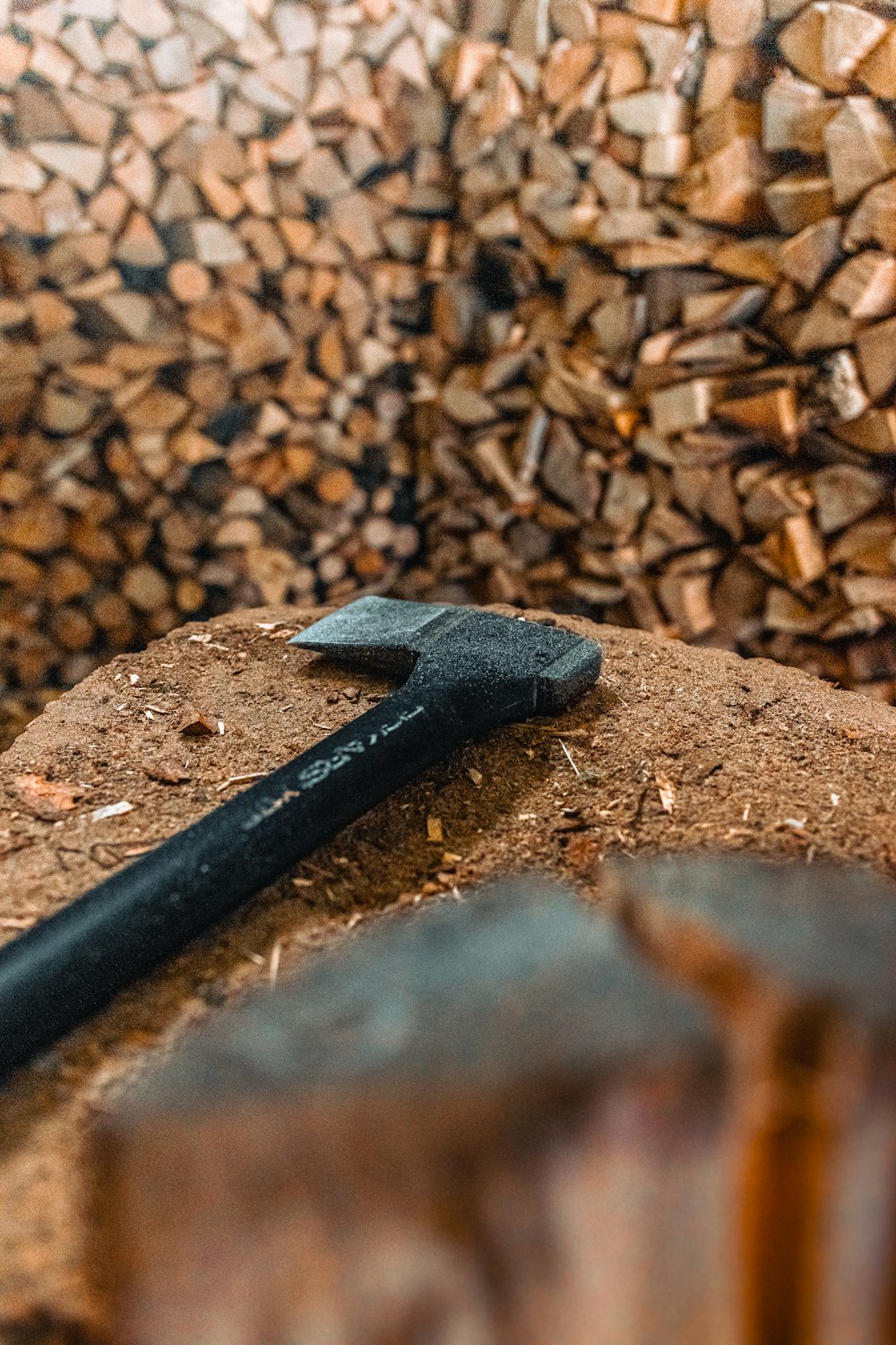 a hammer and a piece of wood sitting on top of a pile of wood
