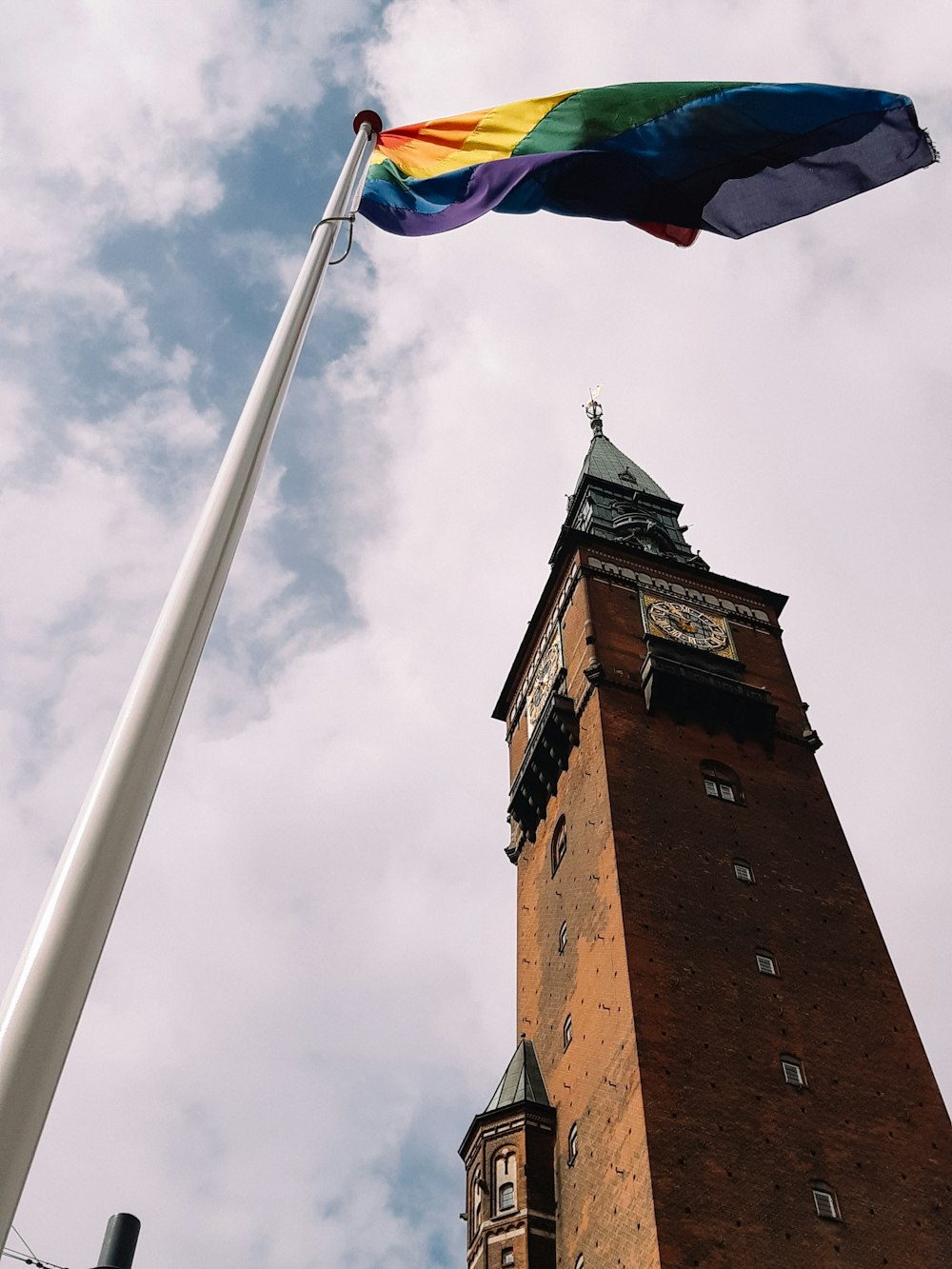 a tall tower with a rainbow flag on top of it