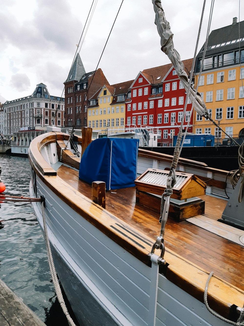 a boat docked in a harbor with buildings in the background