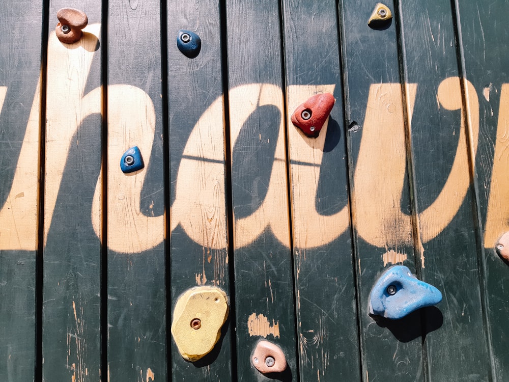 a close up of a climbing wall with a name on it