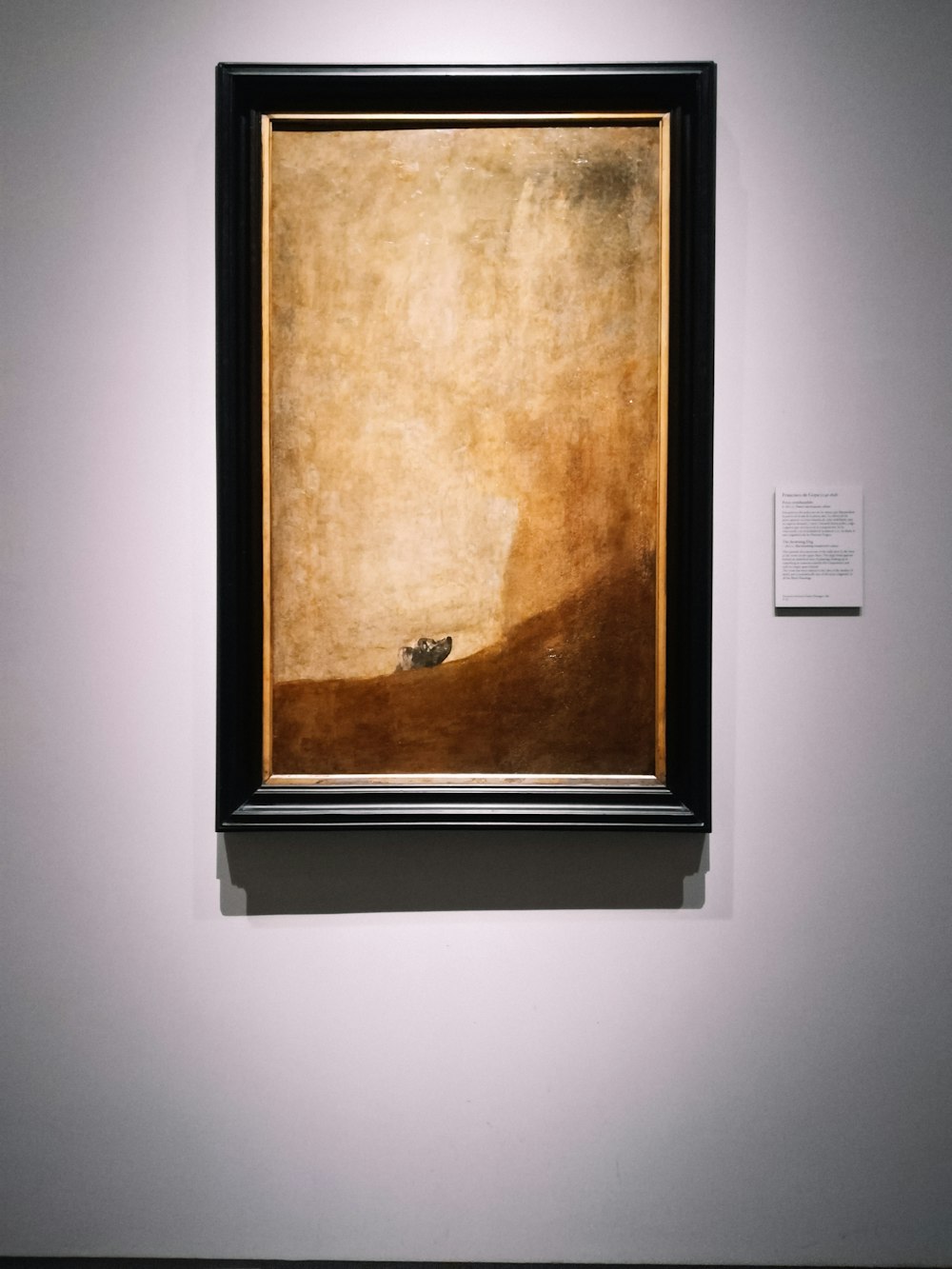 a painting hanging on the wall of a museum