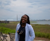 a woman standing in front of a row of benches
