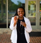 a woman holding a stethoscope in her right hand