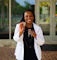 Smiling woman holding a dna verify test kit outdoors.