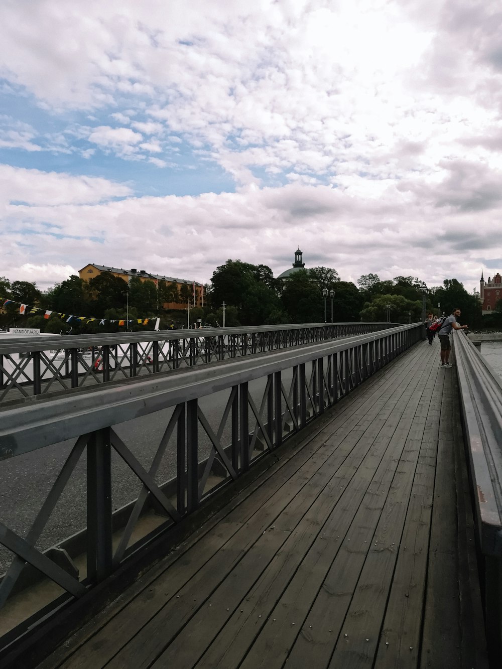 a person walking across a bridge over a body of water