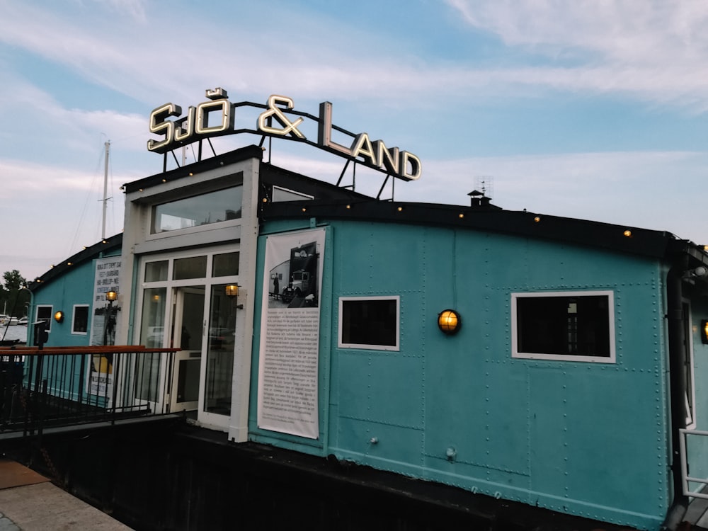 a blue building with a sign on top of it