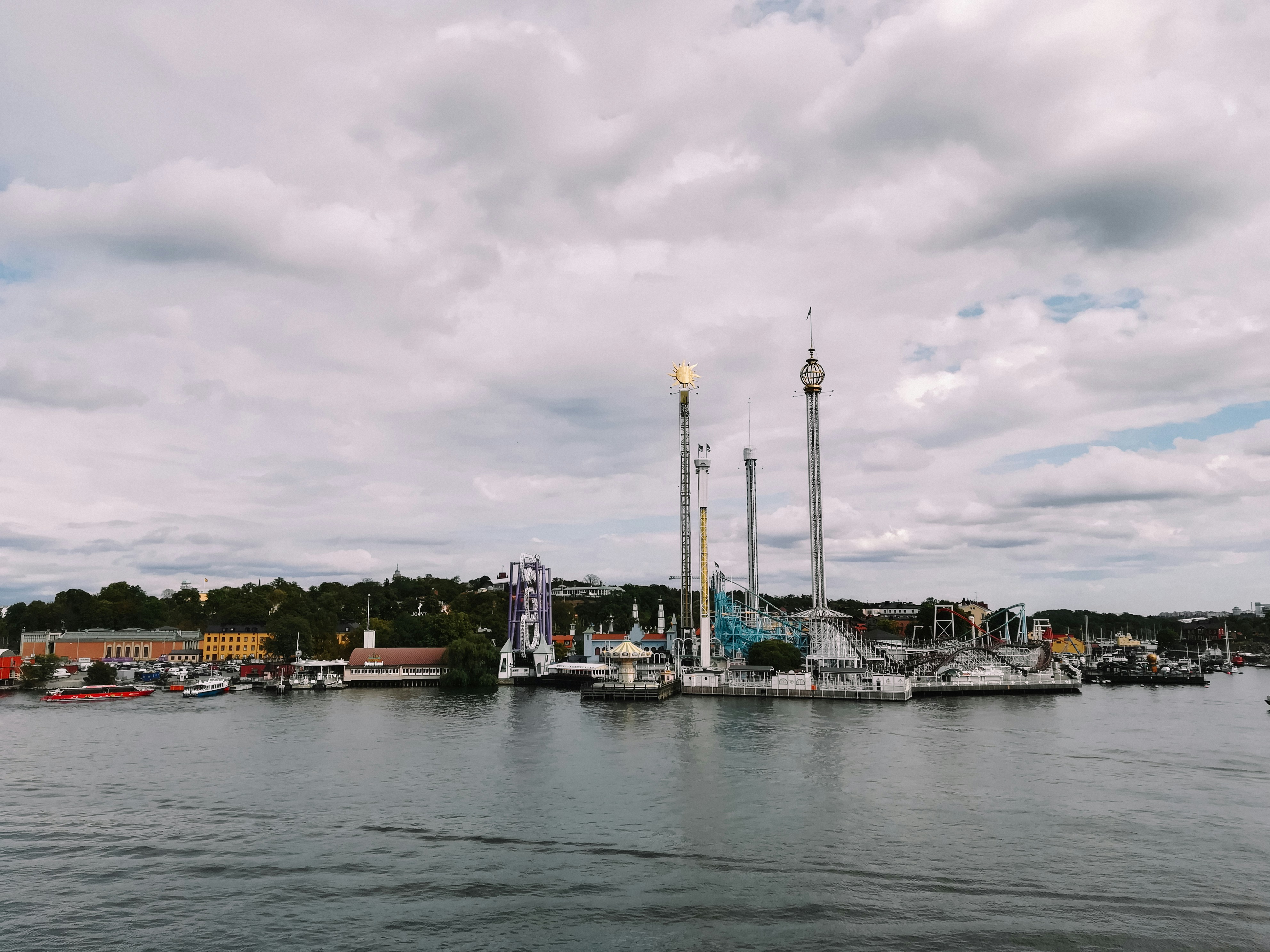 a harbor filled with lots of boats under a cloudy sky
