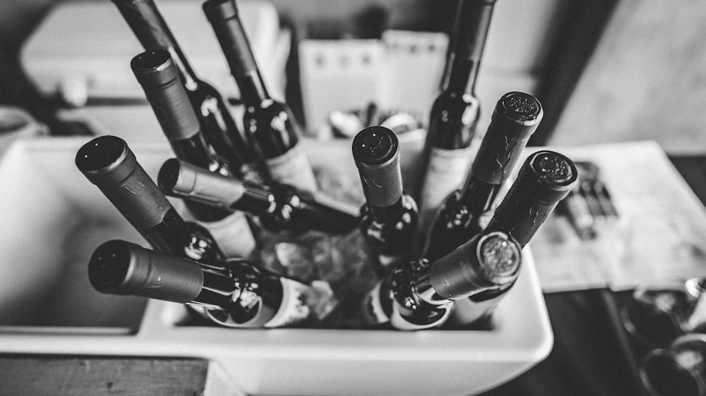 a bunch of wine bottles that are in a bowl