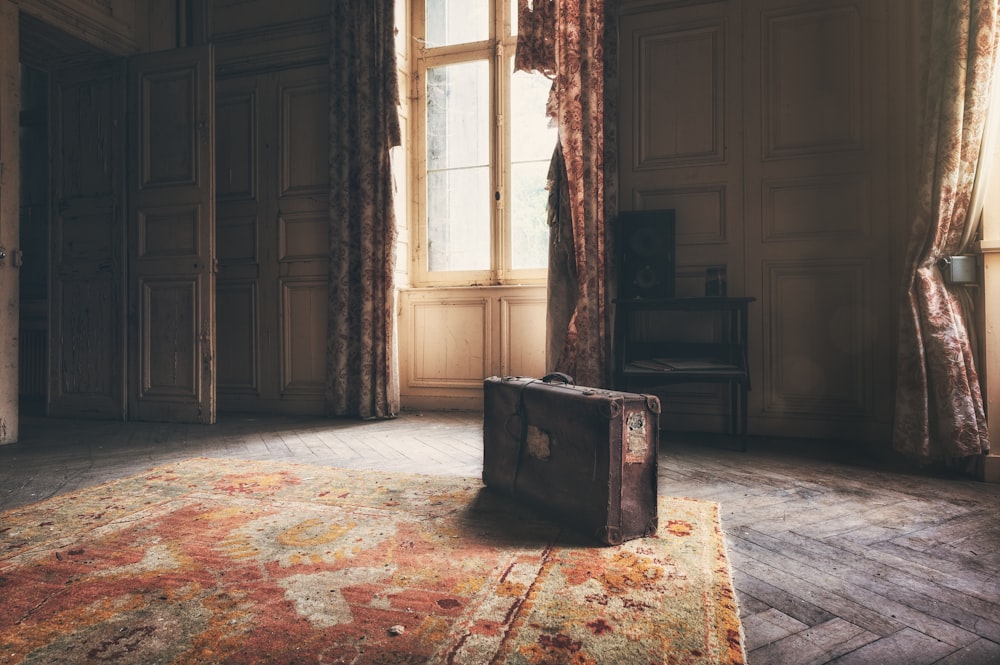 a suitcase sitting on a rug in a room