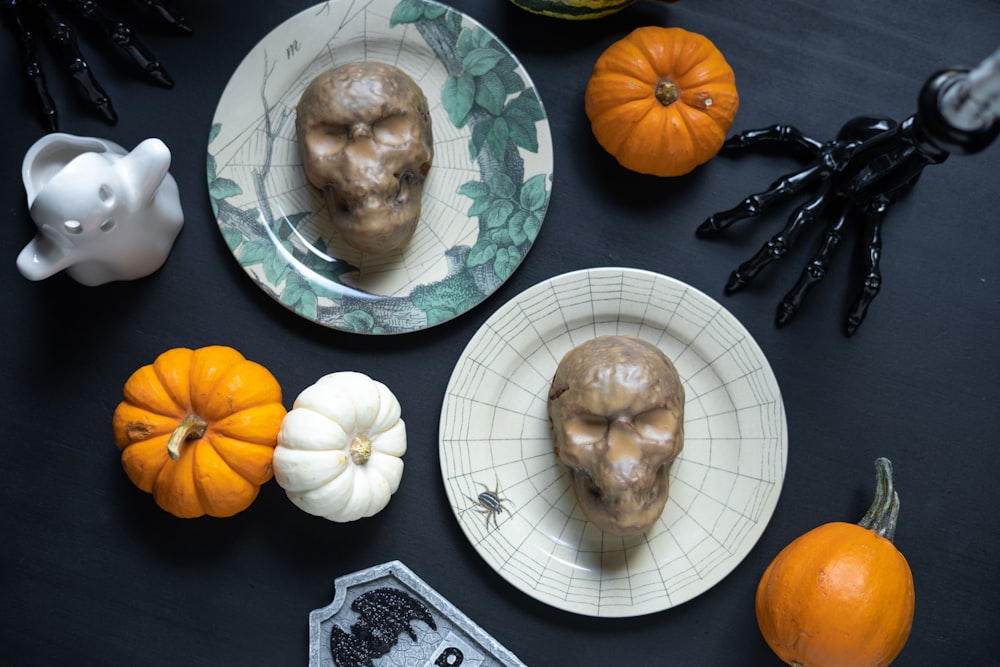 a table topped with plates of food and halloween decorations
