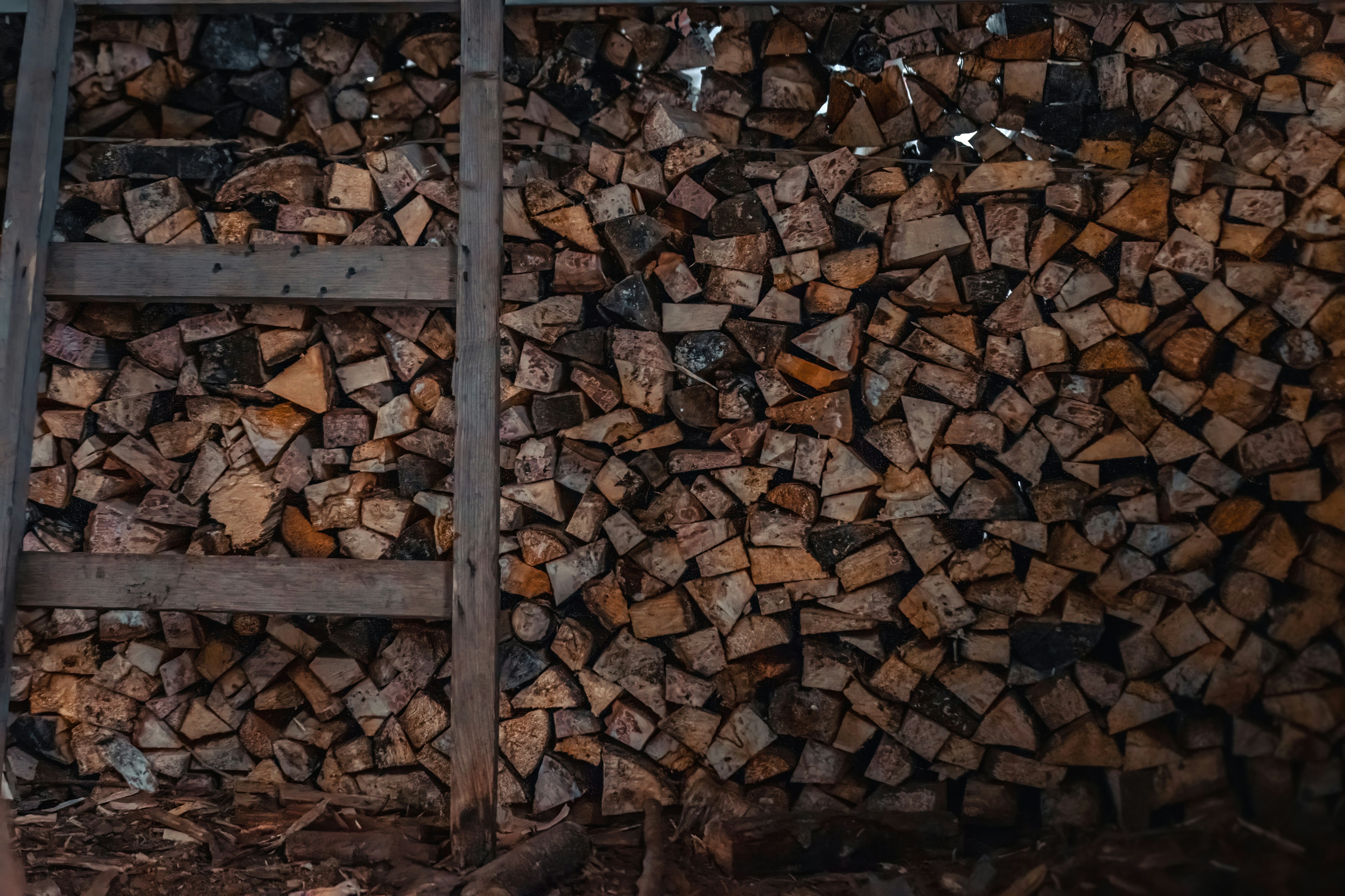 a pile of wood sitting next to a ladder