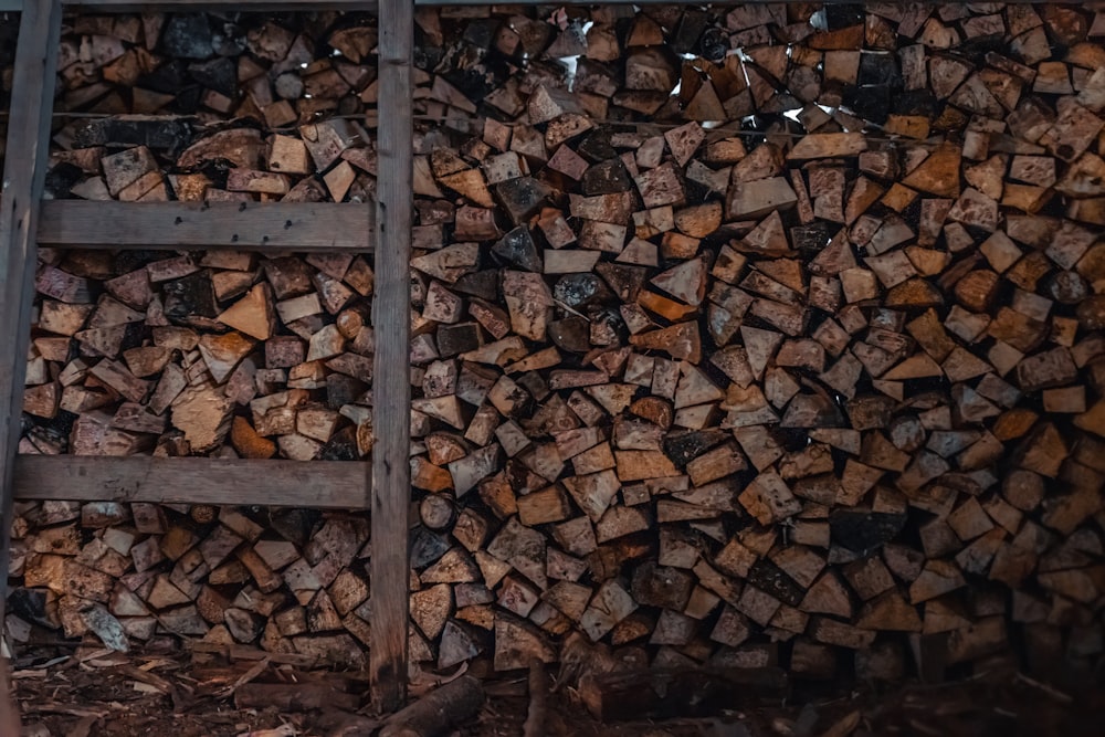 a pile of wood sitting next to a ladder