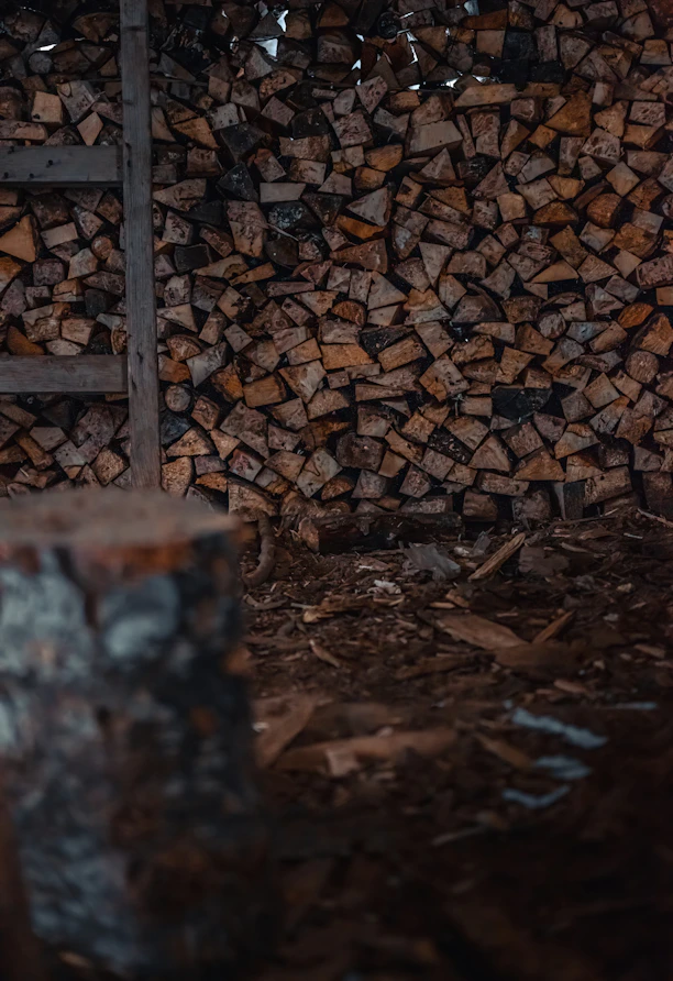 a pile of wood sitting next to a ladder