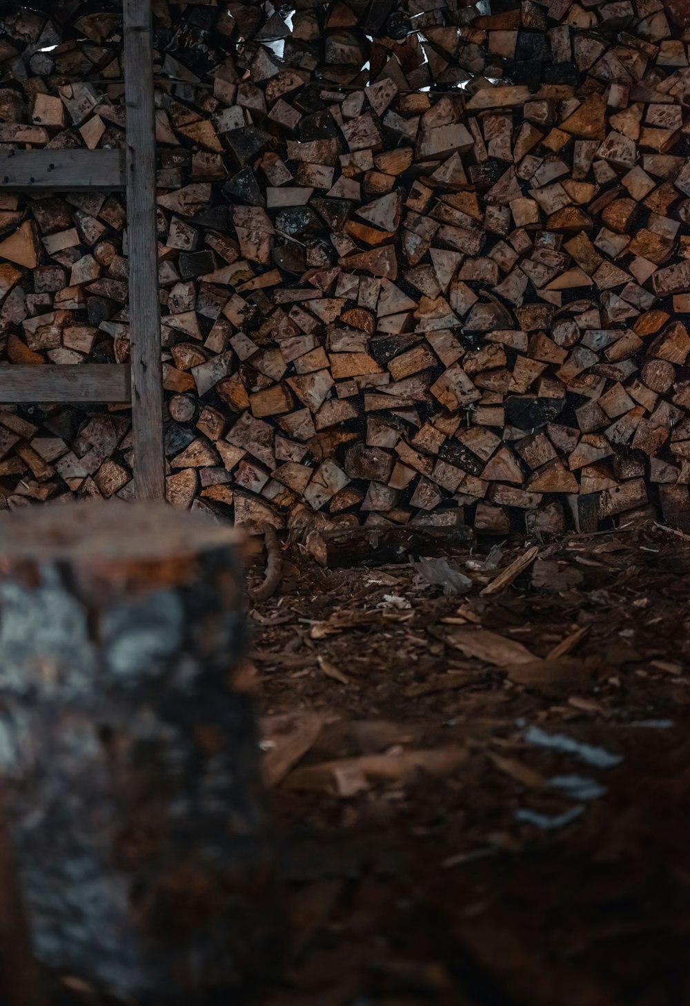 a pile of wood sitting next to a ladder