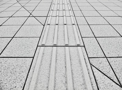a black and white photo of a tiled walkway