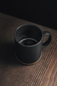 Charcoal mug on dark wood