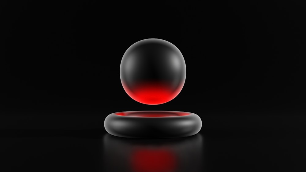 a black and red object on a black surface