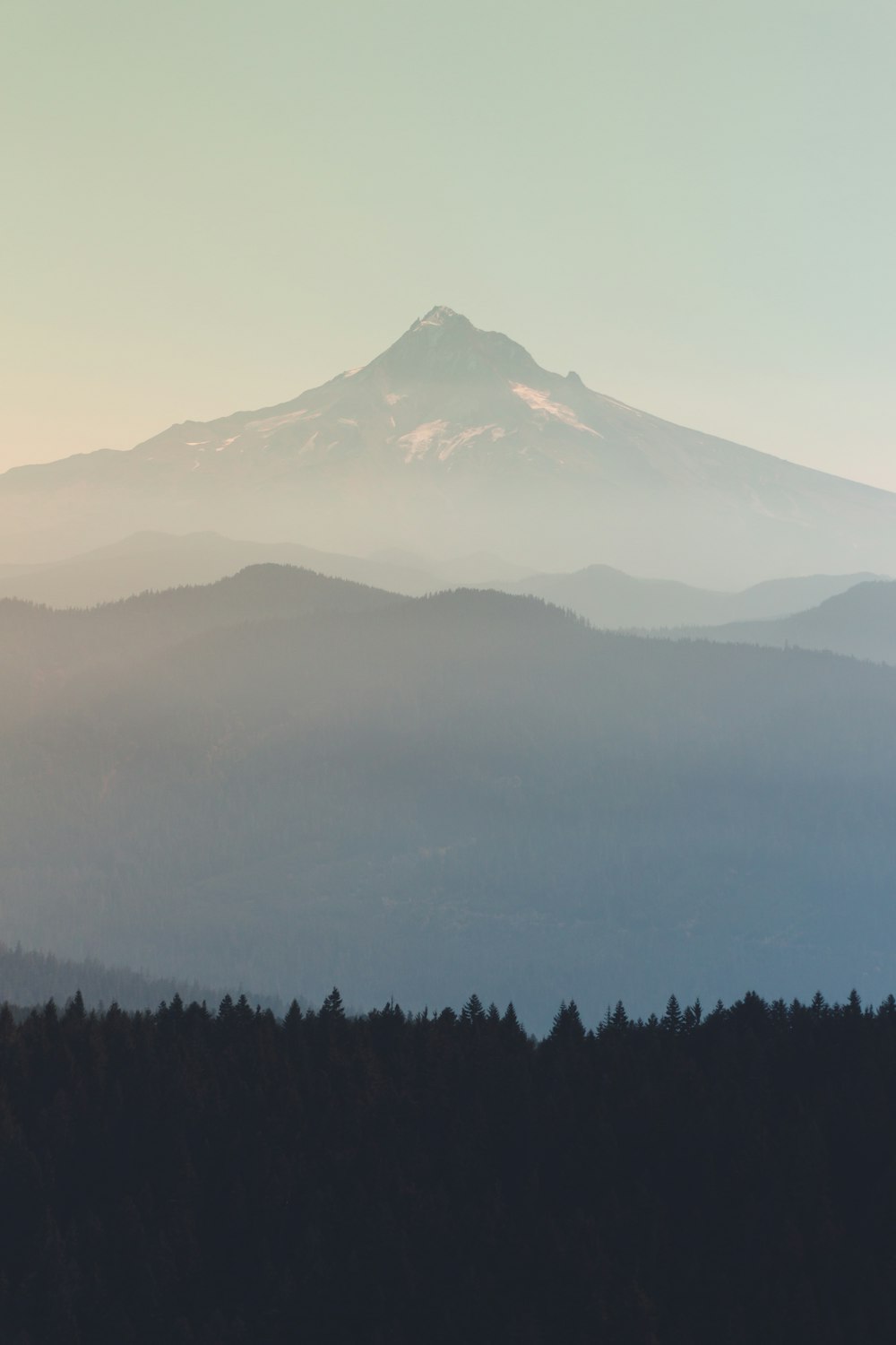 a view of a mountain with trees in the foreground