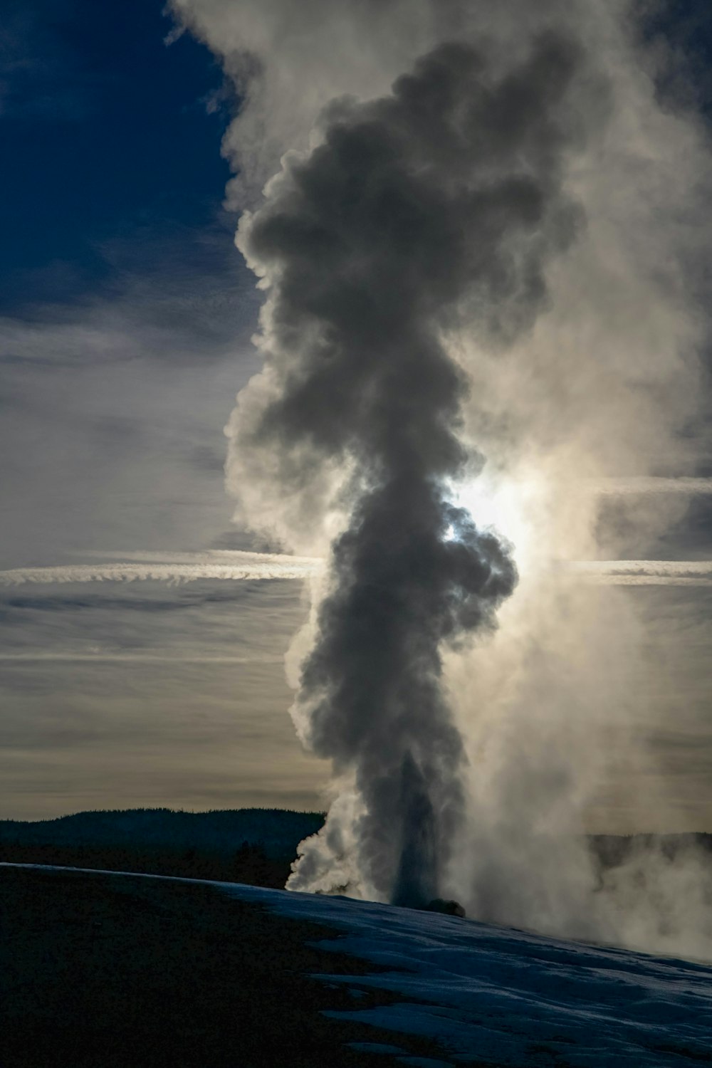 a train on a track with smoke coming out of it