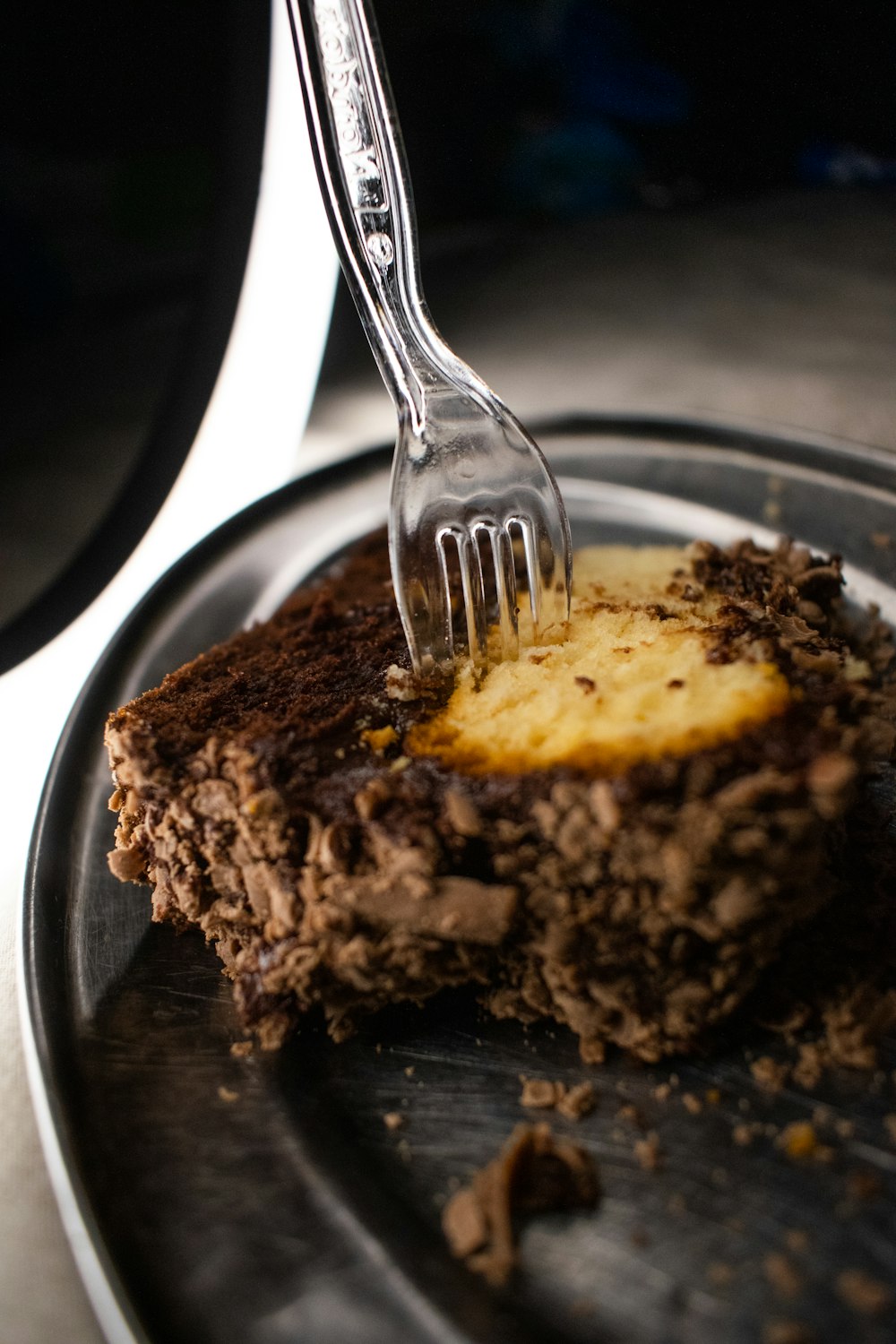 a piece of chocolate cake on a plate with a fork