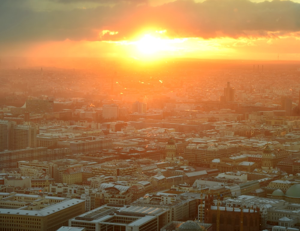 the sun is setting over a large city