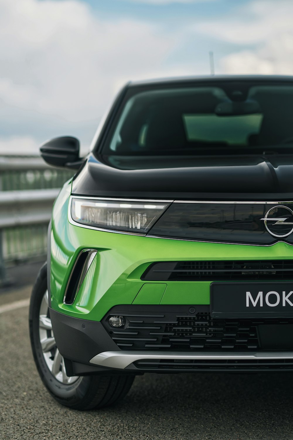 a green car parked on the side of the road