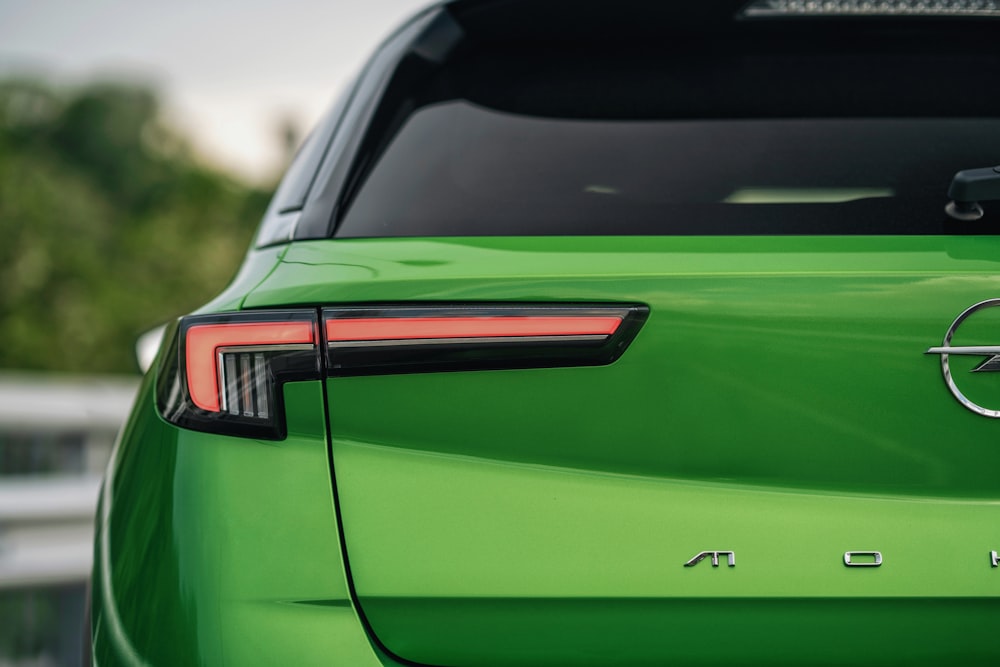 a close up of the tail lights of a green car
