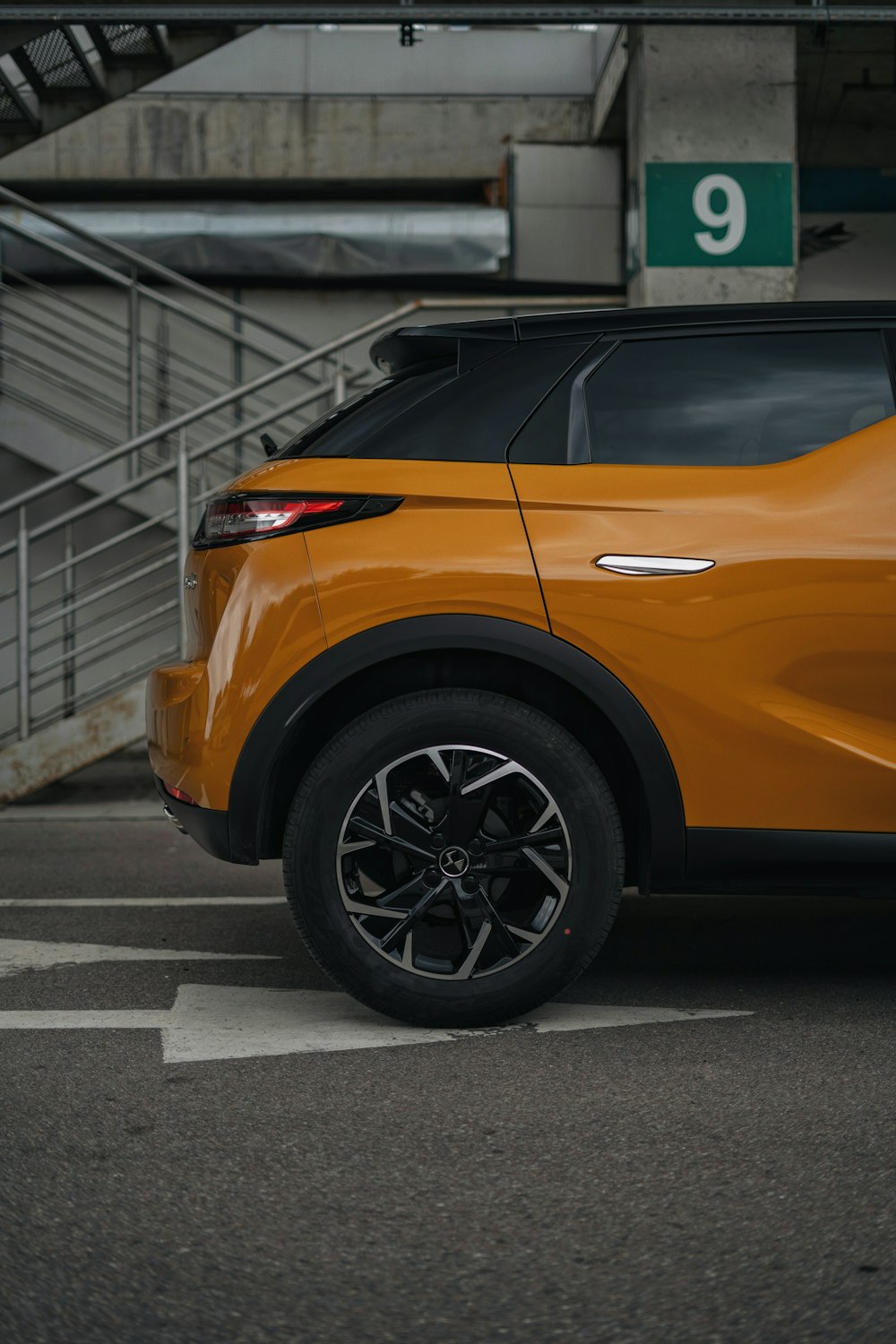 an orange car parked in a parking lot