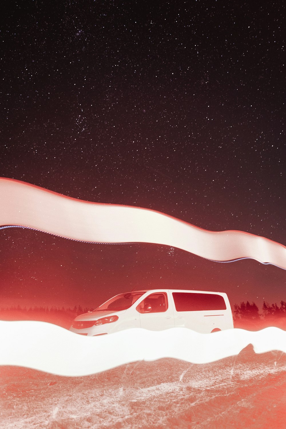 a white van driving through a snow covered field