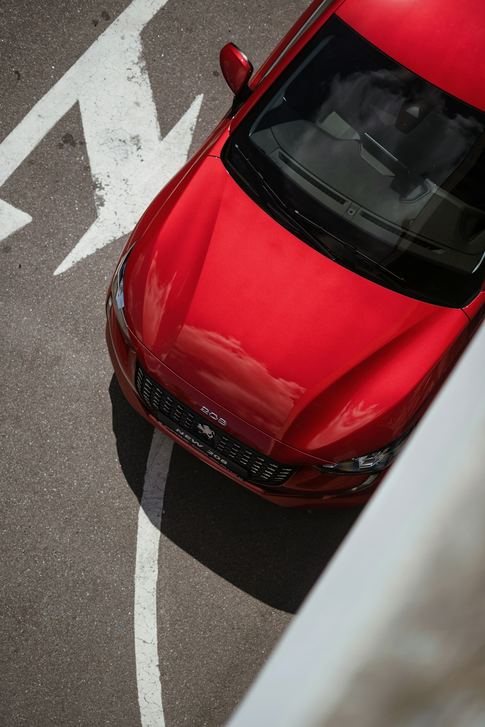 a red car is parked in a parking lot