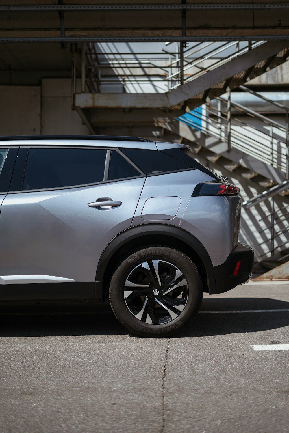 a silver car parked in front of a set of stairs