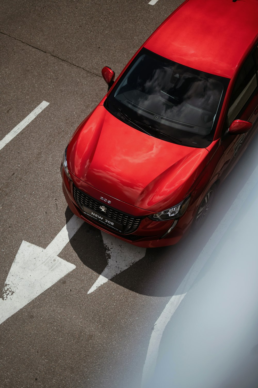 a red car is parked in a parking lot