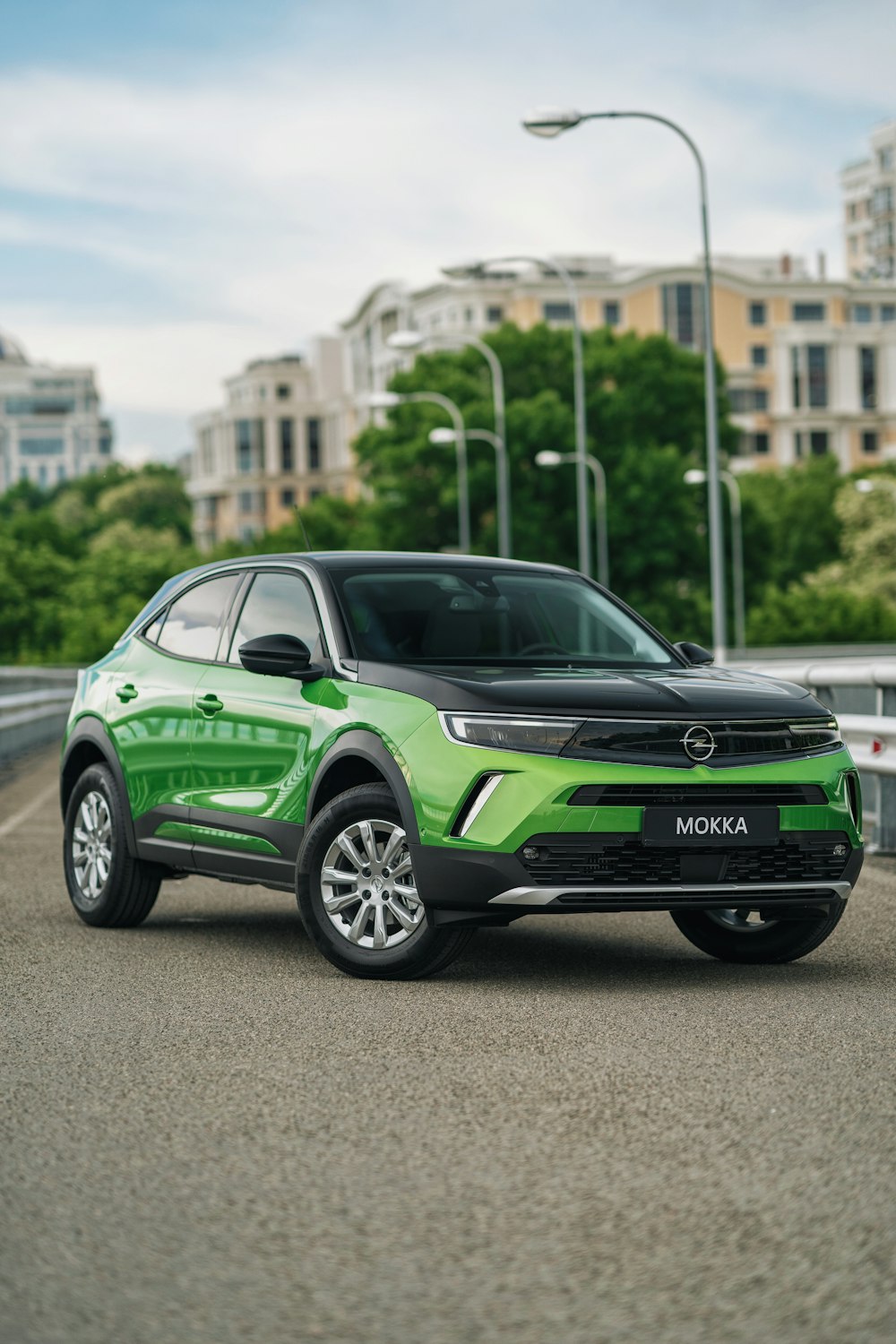 a green suv is parked on the side of the road