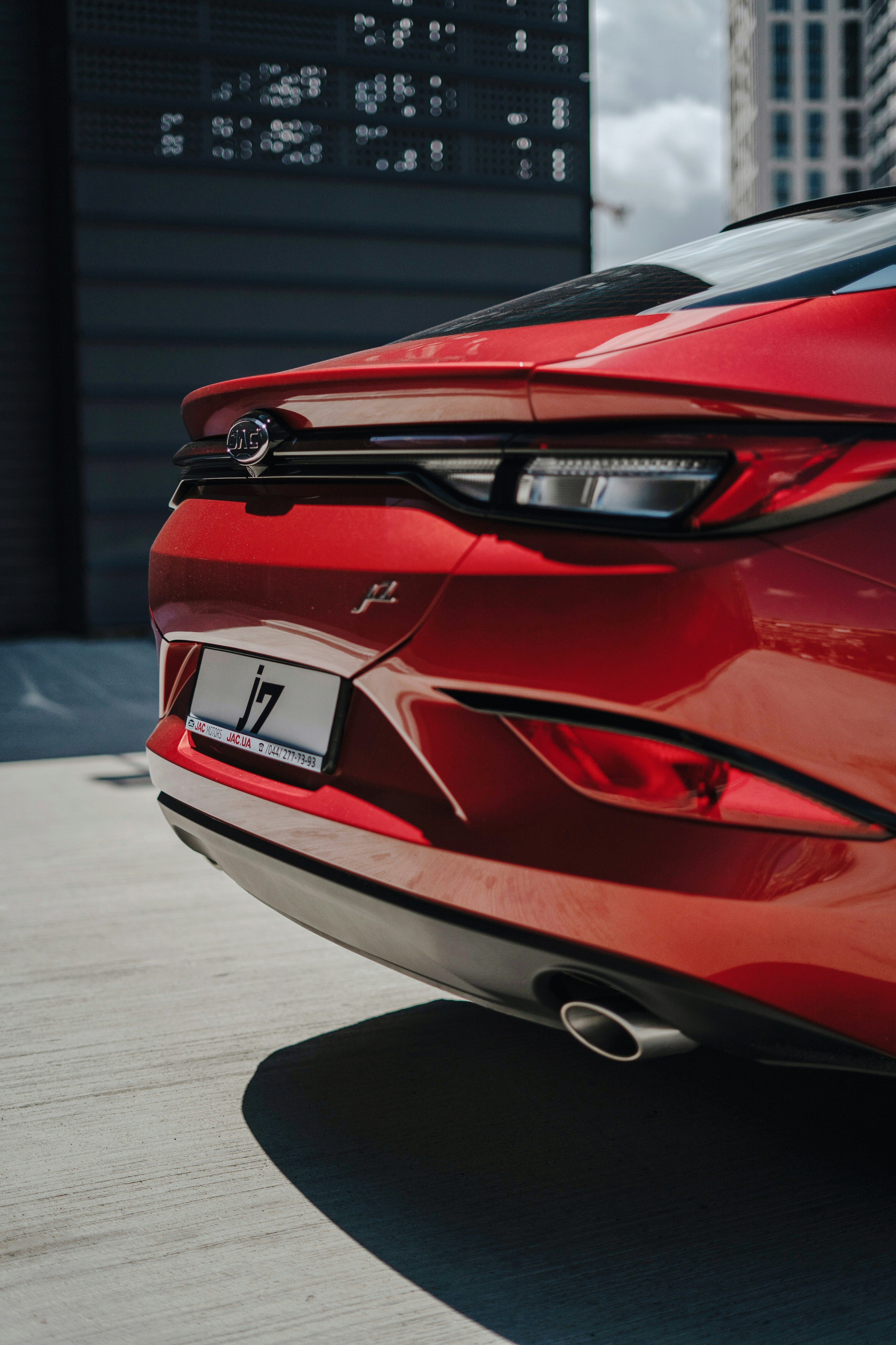 a close up of the rear end of a red sports car