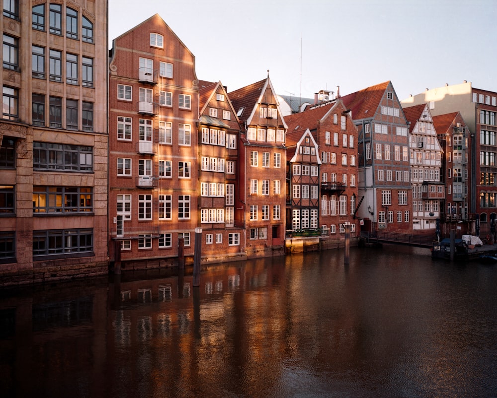 a row of buildings next to a body of water