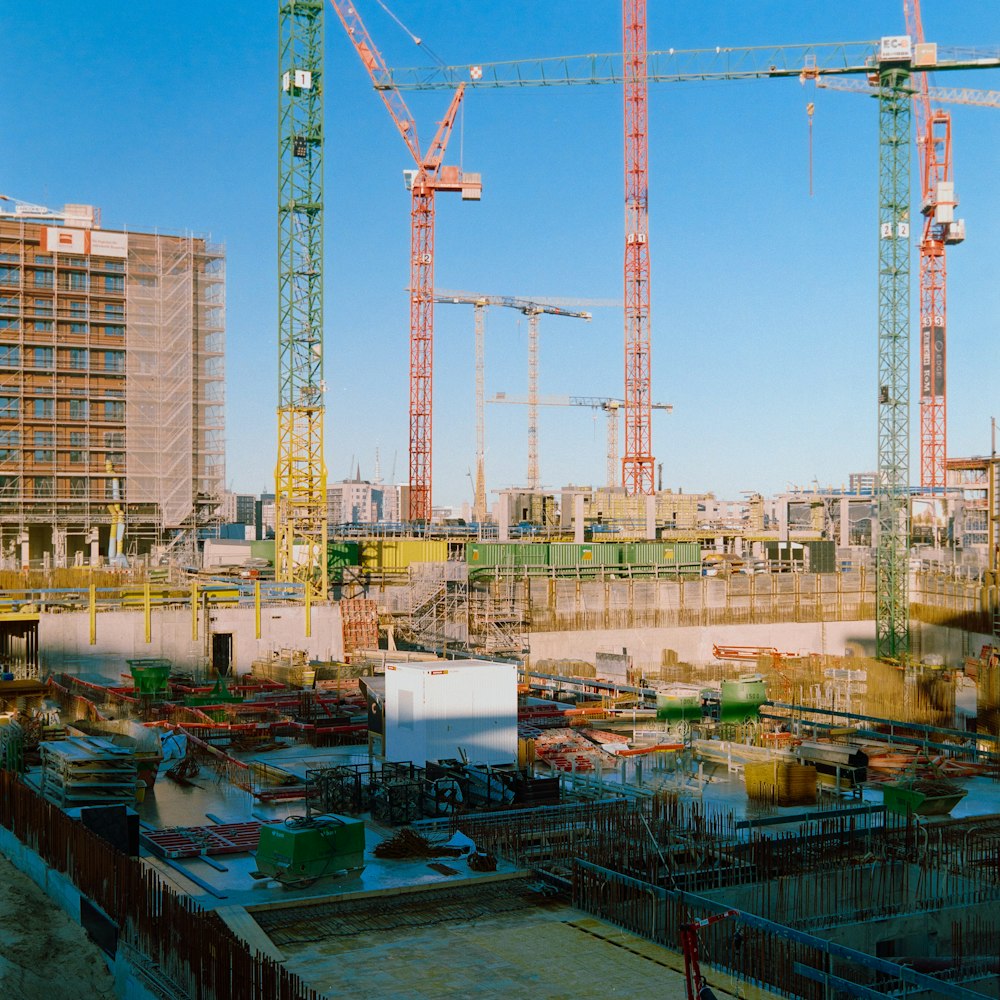 a bunch of cranes that are in the air