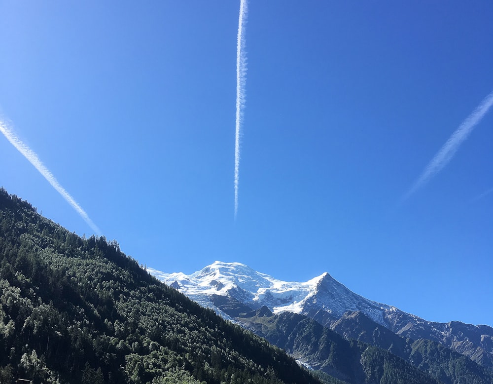 a person flying through the air on a snow covered mountain