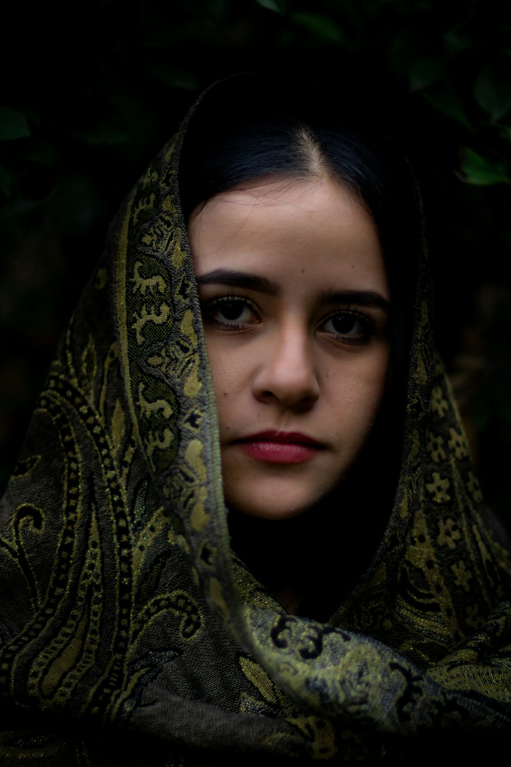 a woman with a scarf over her head