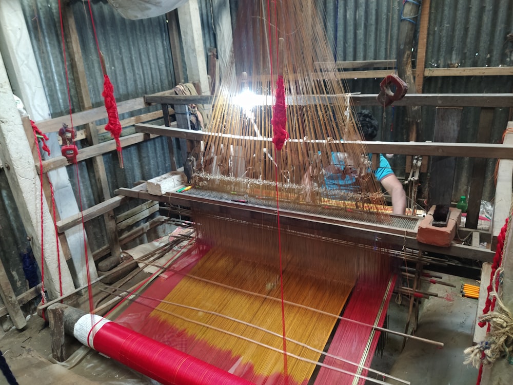 a weaving machine with a red cloth on it