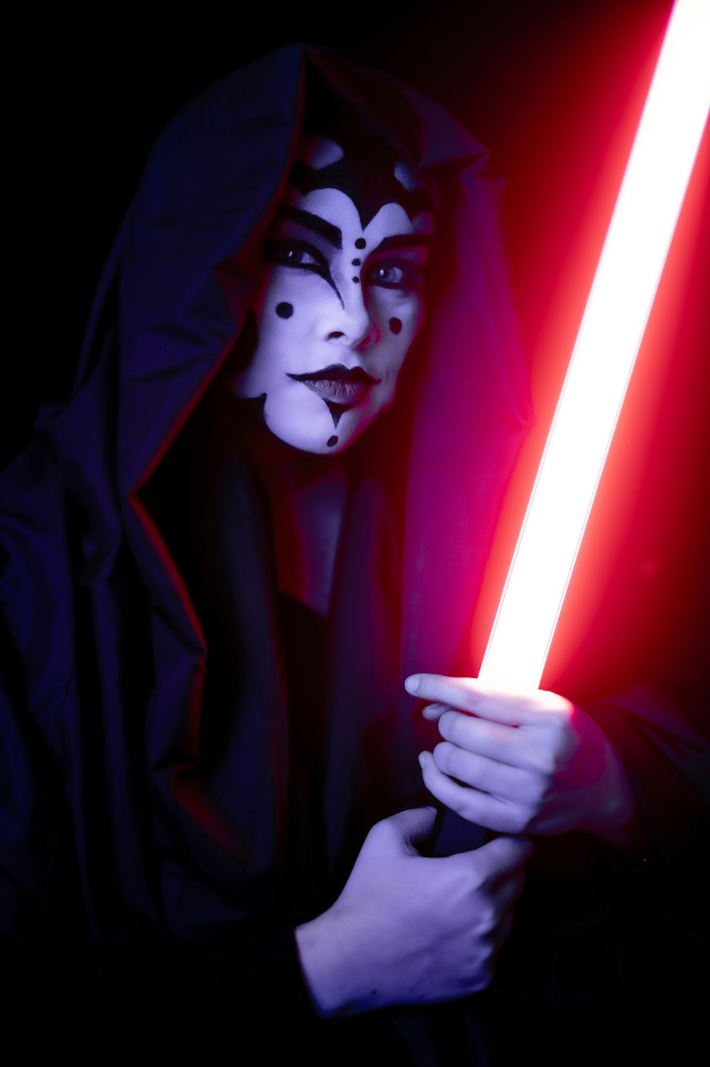 a person in a costume holding a light saber