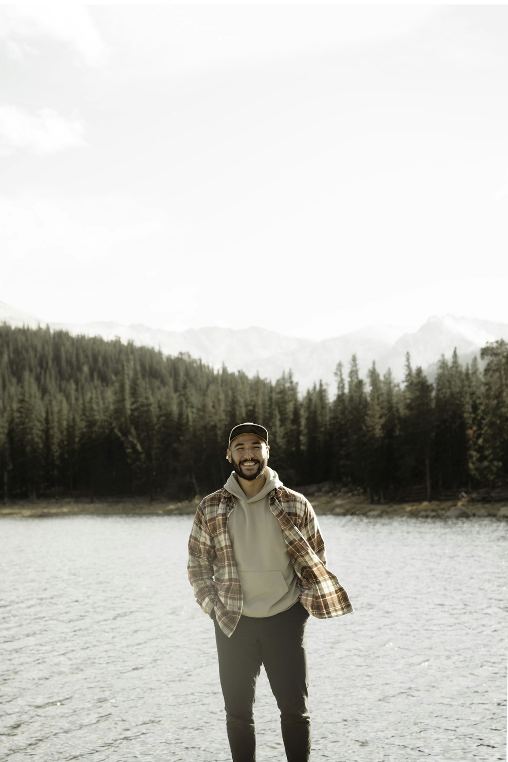 a man standing in front of a body of water