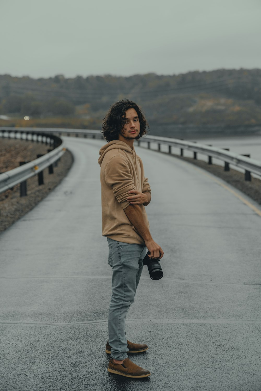 a man standing in the middle of a road